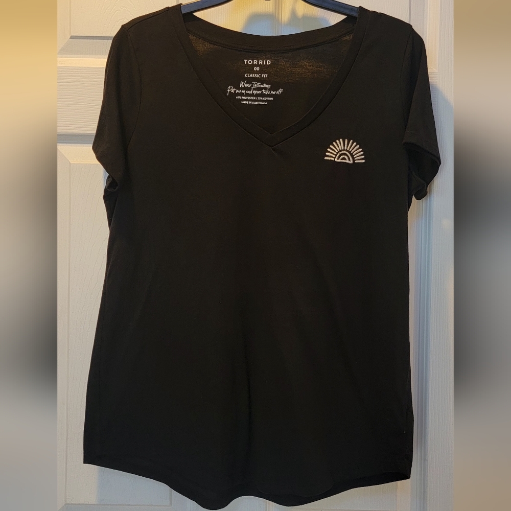 women's Torrid black tshirt with sun stitching on the left hand side